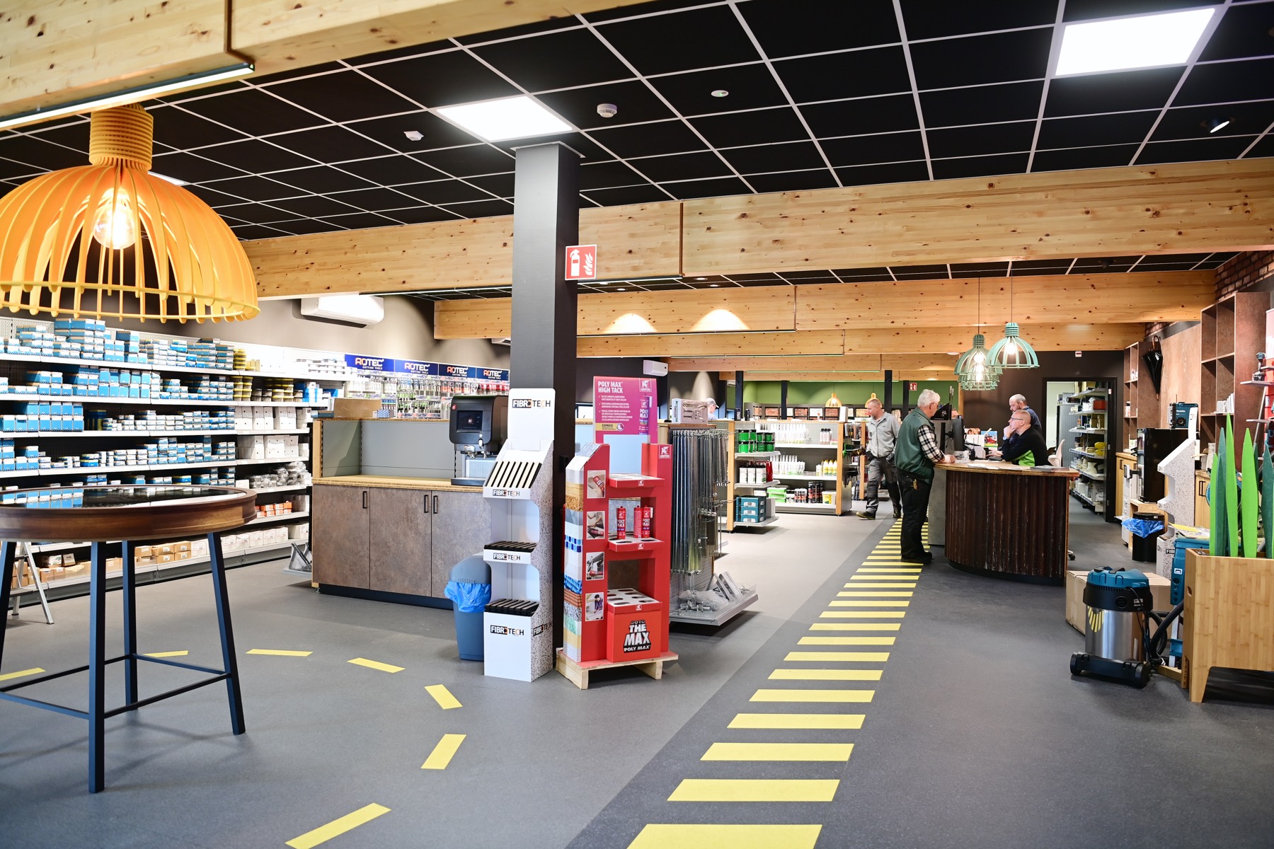 De winkelvloer van Miedema Bouwmaterialen in Leeuwarden met een medewerker die een klant adviseert aan de balie